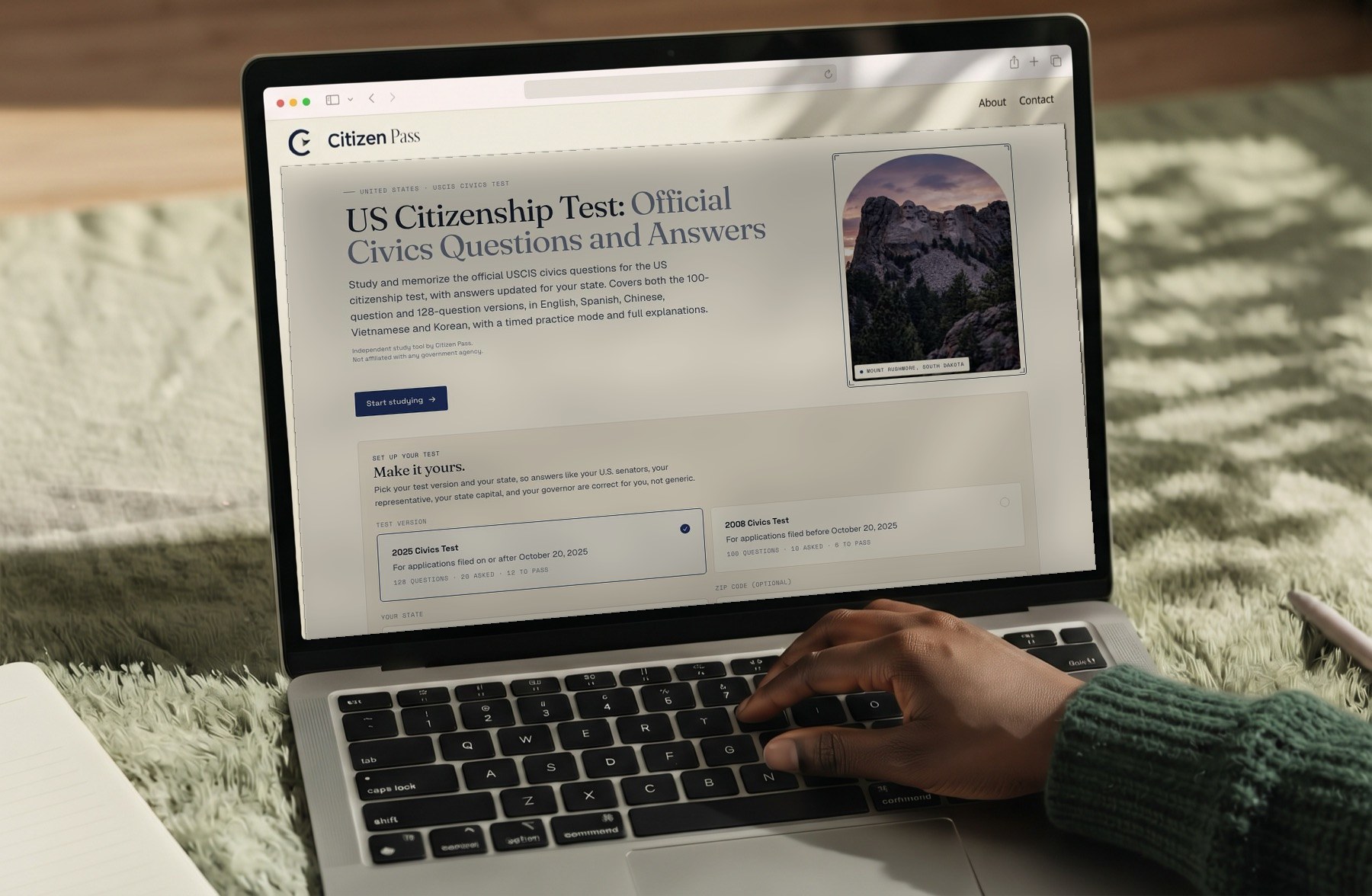 Citizen Pass website on a laptop with an airplane wing over clouds